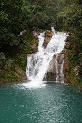 Cascading Forest Waterfall with Turquoise Pool © TrieuHao