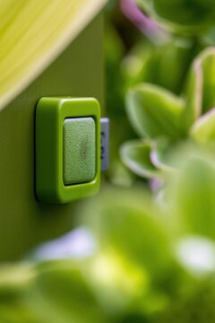 Electronic key card reader on a green wooden hotel door, featuring a smooth lacquer finish and engraved room number for hospitality and travel concepts