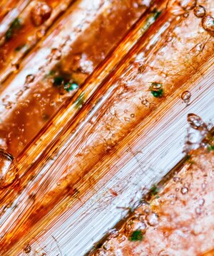 Amber translucent gel texture with glossy striations and microscopic bubbles for medical healthcare layouts and blood sugar monitoring concepts