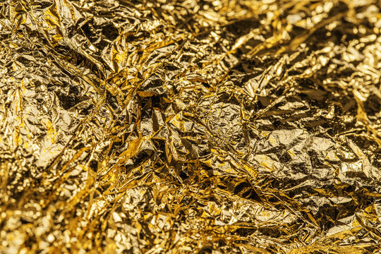 textured gold foil shimmering with metallic light