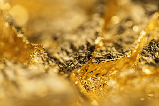 pieces of gold foil with a crumpled texture and bright shine