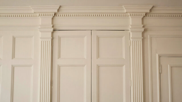 Classic wooden wall paneling with integrated door and molding, paneling