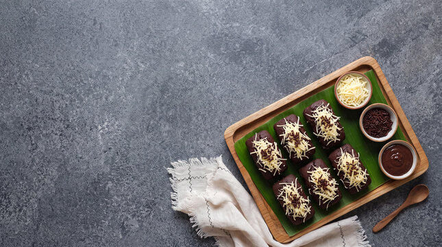 Six chocolate kue balok with cheese and sprinkles topping