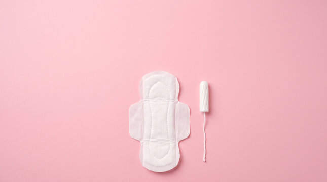 Clean flat lay of essential menstrual hygiene products on a pastel pink background with ample copy space.