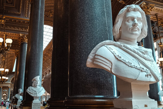 Paris, France - 02 April 2026: View of marble busts and ornate columns inside the opulent Opera Garnier, featuring intricate gold detailing and classical architecture.