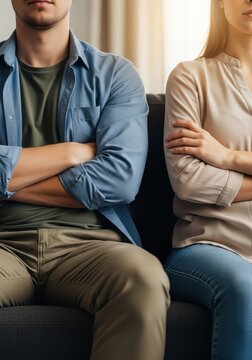 Unhappy Couple Sitting on Sofa with Crossed Arms After Argument Representing Relationship Conflict and Communication Problems