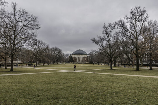 Champaign, Illinois, United States - 18 January 2017: View of Foellinger Auditorium at the University of Illinois Urbana-Champaign, with bare trees and a grassy quad on a cloudy day.
