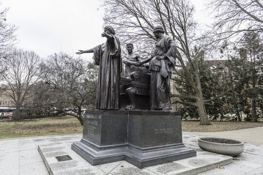 Champaign, Illinois, United States - 18 January 2017: View of the Alma Mater statue at the University of Illinois Urbana-Champaign, featuring bronze figures on a stone base.