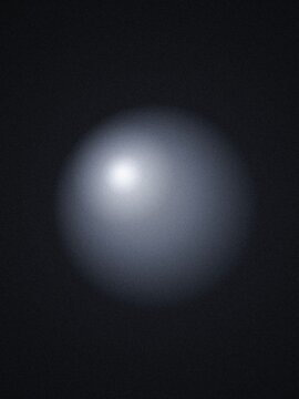 A glowing white sphere floating in deep darkness, creating a soft light effect with smooth gradients