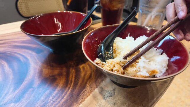 Eating Mapo Tofu with White Rice Using Chopsticks in Restaurant