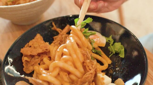Close Up of Person Mixing Burmese Nan Gyi Tote Noodle Salad