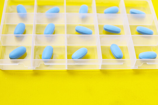Blue PrEP pills organized inside a plastic pill box