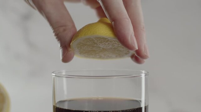 Squishing lemon in glass. Original sound. 24fps. Prores 422HQ