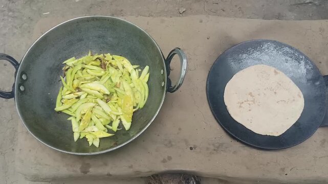 Cooking Roti and Vegetable on Traditional Clay Stove in Rural Kitchen