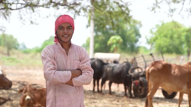 young indian farmer standing at buffalo farm