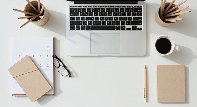 Modern minimalist home office desk with laptop and accessories.
