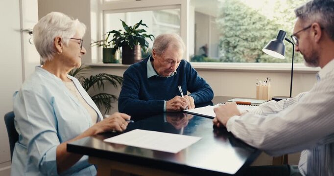 Advisor, old couple and signature at house with document, application and notary for last will. Consultant, meeting and senior people in home with paperwork, contract consent and inheritance annuity