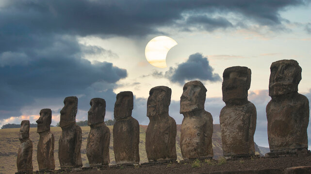 Moai statues on Easter Island at Ahu Tongariki against conceptual solar eclipse with copy space