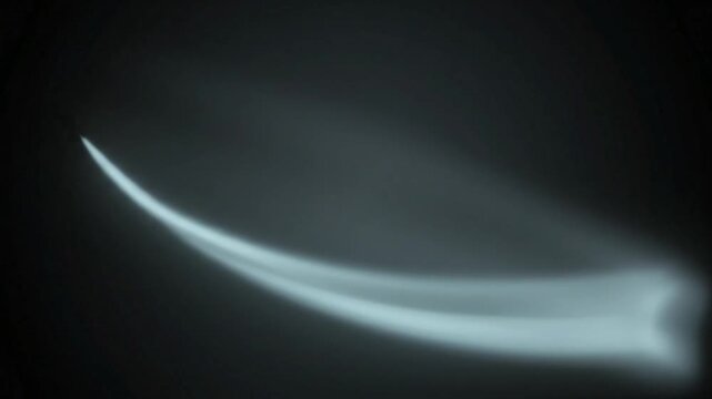 Glowing light beam streaks moving through dark atmosphere captured in dynamic motion video footage for abstract futuristic background visual effects