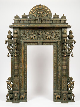 South Indian temple doorway frame with green bronze patina, animal reliefs, carved pillars and ornate architectural crown