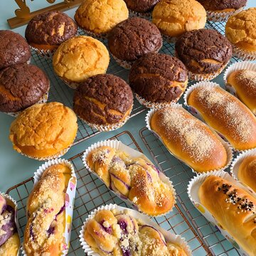 Assorted Freshly Baked Bread and Pastries on Cooling Racks