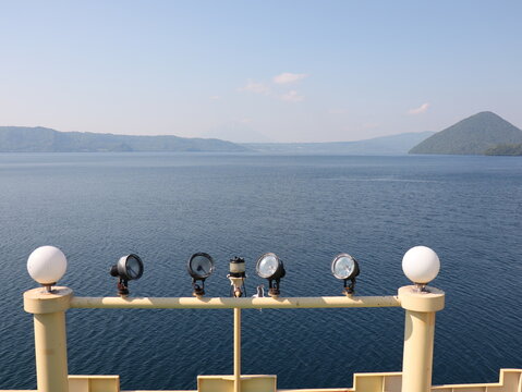 Yellow boat deck railing overlooking Lake Toya in Hokkaido