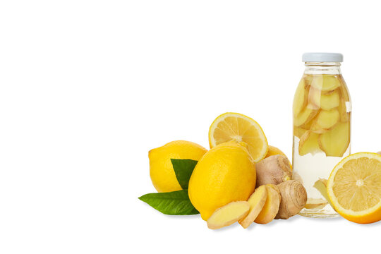 Bottle with ginger and lemon next to whole lemons, isolated, PNG