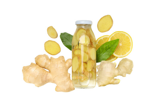 Ginger slices surround a bottle of lemon ginger water, isolated, PNG