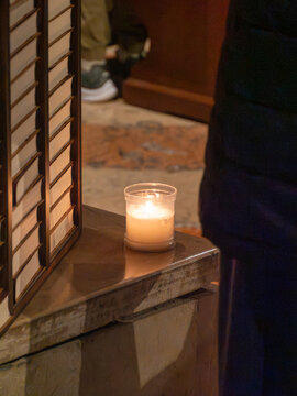 Cremona, Italy - 02 February 2026: View of a lit candle in a glass holder during the Blessing of Candles mass inside Cremona Cathedral, Santa Maria Assunta.