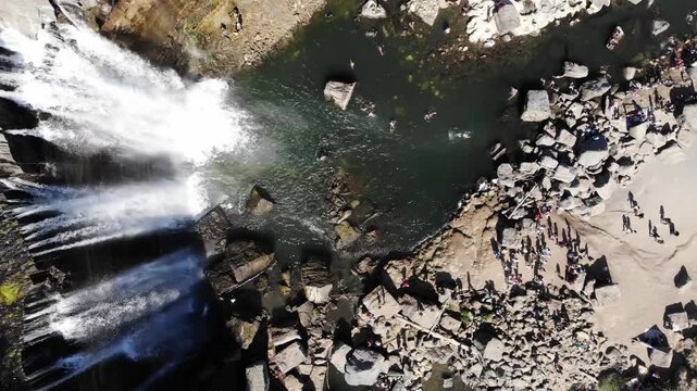 Drone video soars over the Fairy Pools&rsquo; turquoise cascades on Isle of Skye, capturing swimmers in crystal-clear waters, rugged rocks, lush greenery, and bright natural sunlight.