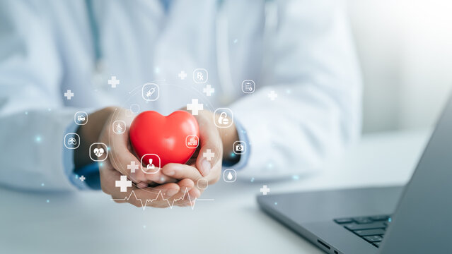 Male medicine doctor hold Red heart healthcare medical for the Health insurance concept in hospital or clinic background