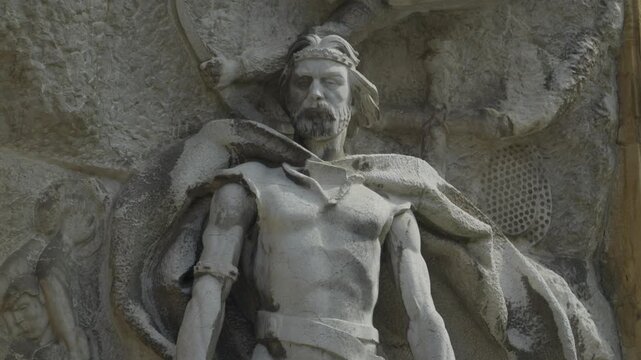 Close up shot detailing heroic warrior figure carved in historic wall mural