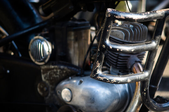Close up of classic vintage motorcycle engine with black crash guard and horn