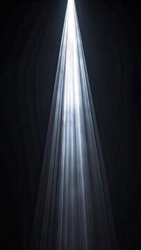 A single bright beam of light shines down, illuminating translucent, rippling fabric.