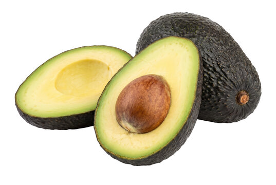 Ripe whole and halved avocados with pit on dark surface