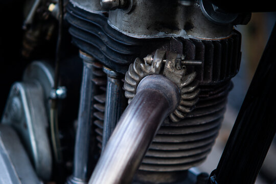 Detail View of Vintage Motorcycle Engine Cylinder Block with Finned Exhaust Pipe Fitting