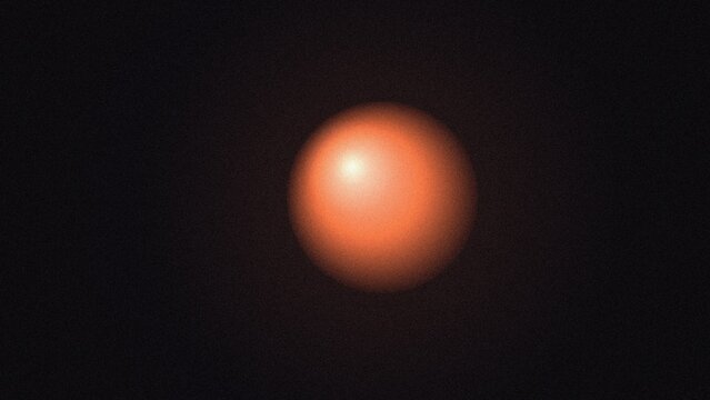 Glowing orange sphere floating in deep darkness with a soft light reflection on its smooth surface
