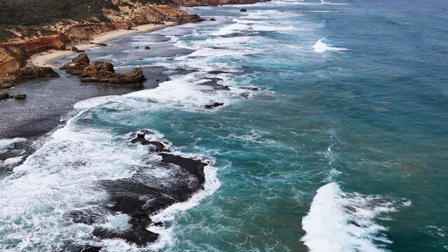 Aerial View of Turquoise Waves Crashing on Sorrento Coastal Rocks