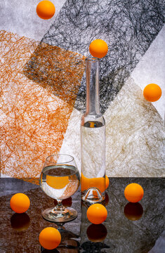 Still life with glassware and orange balls