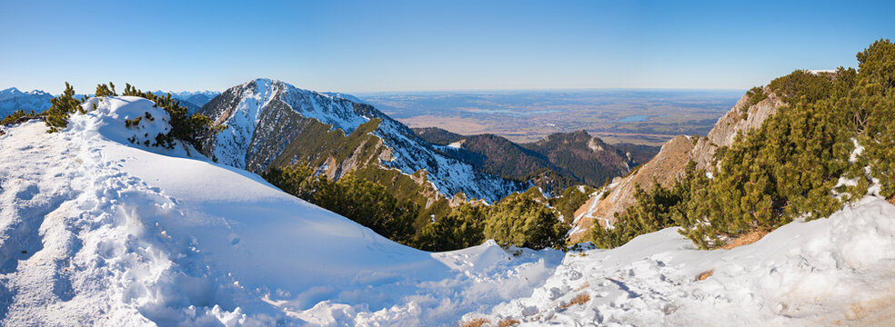 View from the snow-covered hiking trail across the ridge path towards the Heimgarten and the Alpine foothills bavaria