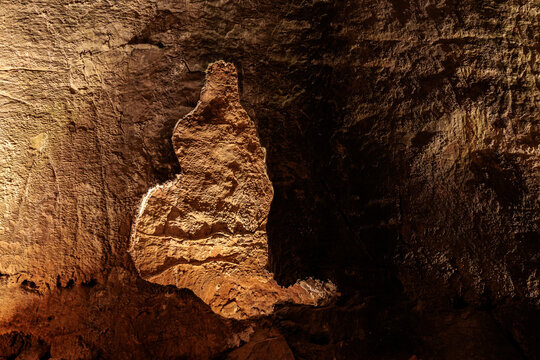 Illuminated shape on the wall inside the Valporquero Cave, Vegacervera, Le&oacute;n, Spain.