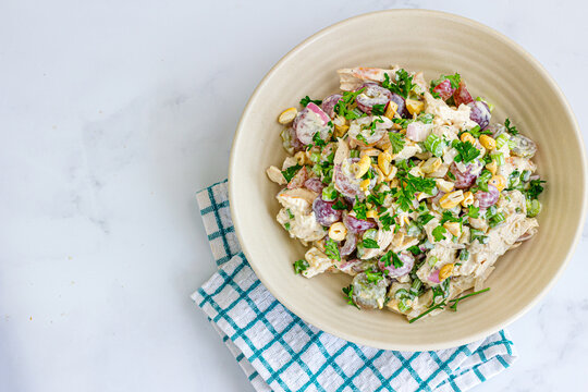 Bowl of creamy chicken salad with grapes and nuts