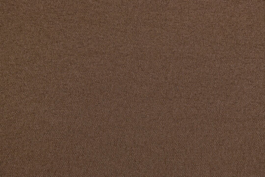 Brown polyester fabric texture abstract dark brown background with fine mesh weave copy space