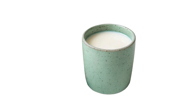 Modern matte green ceramic cup with milk isolated on transparent background cut out