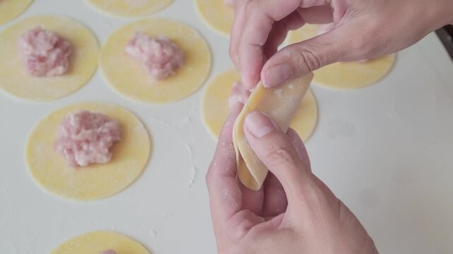 woman makes homemade dumplings, slow motion
