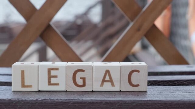 legacy, motivational word, laying out  by hand from letters on wooden cubes, slow motion

