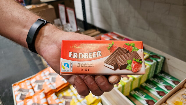 Hand holding ma&icirc;tre truffout erdbeer chocolate bar