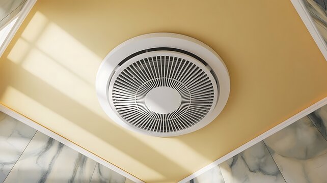 Modern circular ceiling air vent fixture mounted on a yellow ceiling with marble wall tiles in a brightly lit contemporary interior