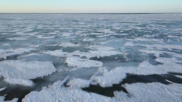 Flying low over Lake St. Clair, a minor Great Lake on the border of Michigan, United States and Ontario, Canada. This shallow lake freezes over regularly and is a popular spot for winter recreation.