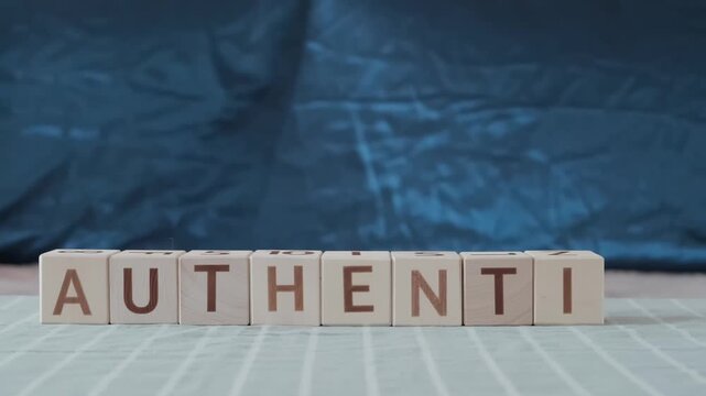 authentic, motivational word, laying out  by hand from letters on wooden cubes, slow motion
